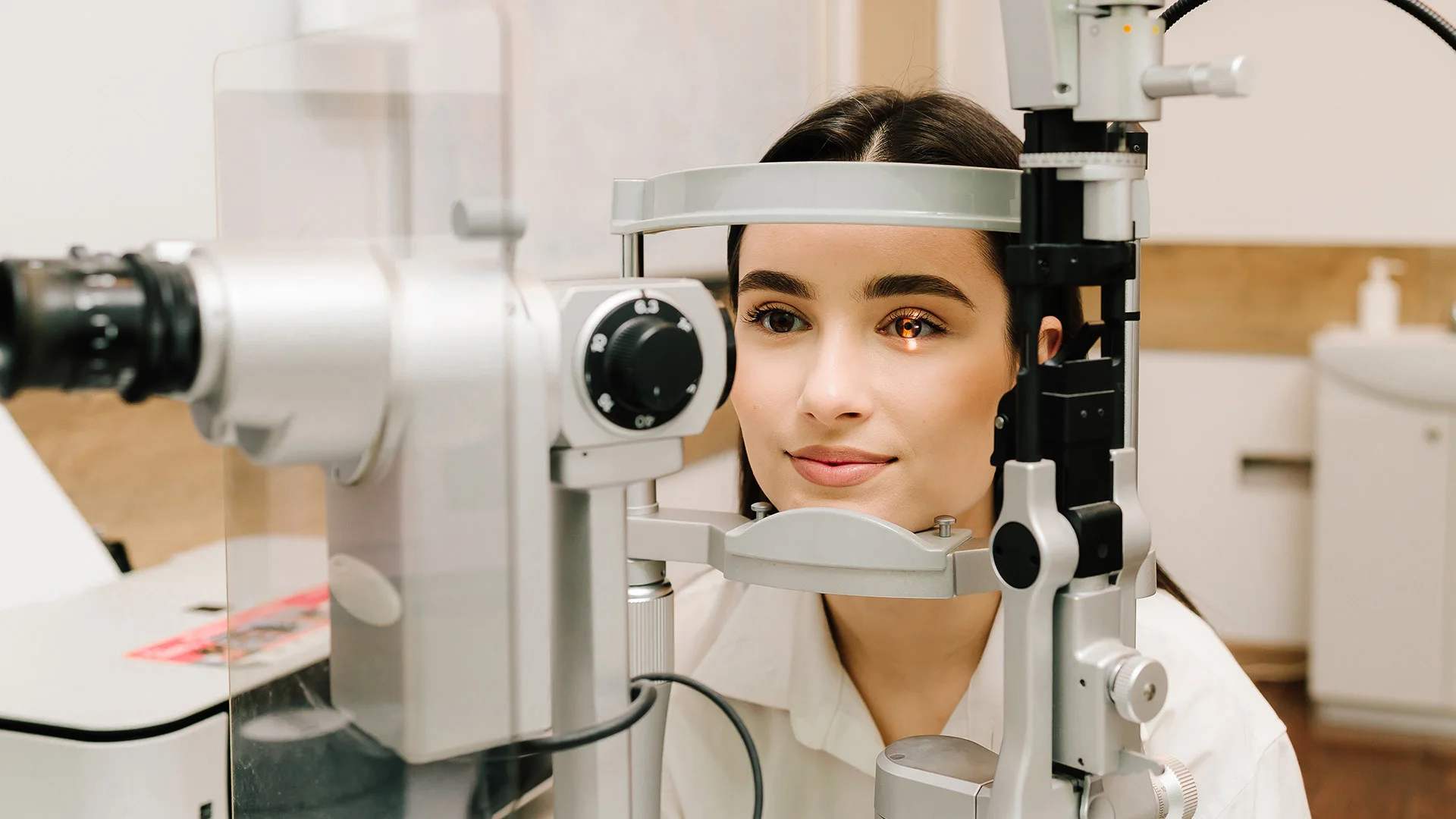 Patient positioned at a slit lamp microscope